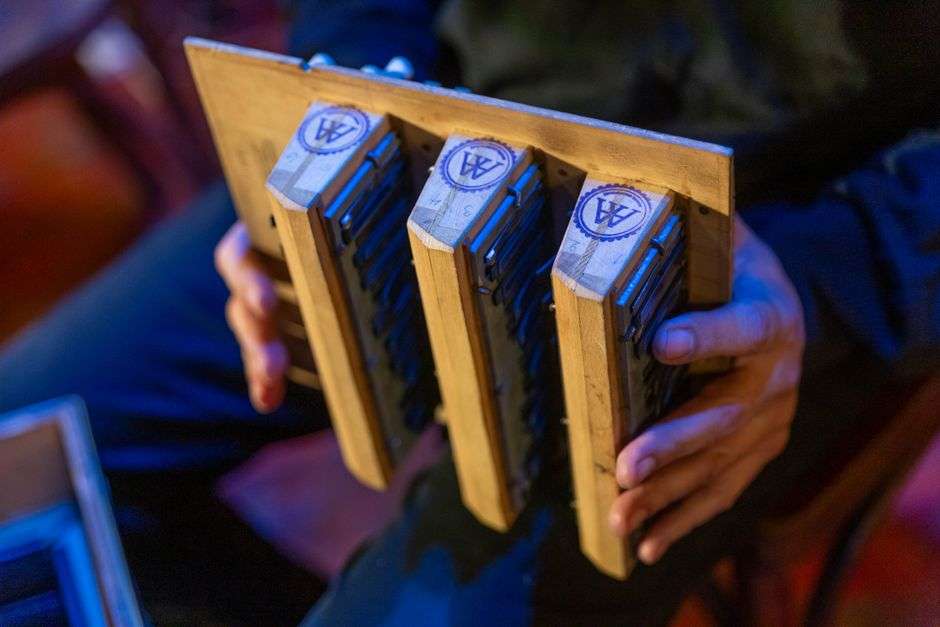 A musician playing harmonica on a small club stage