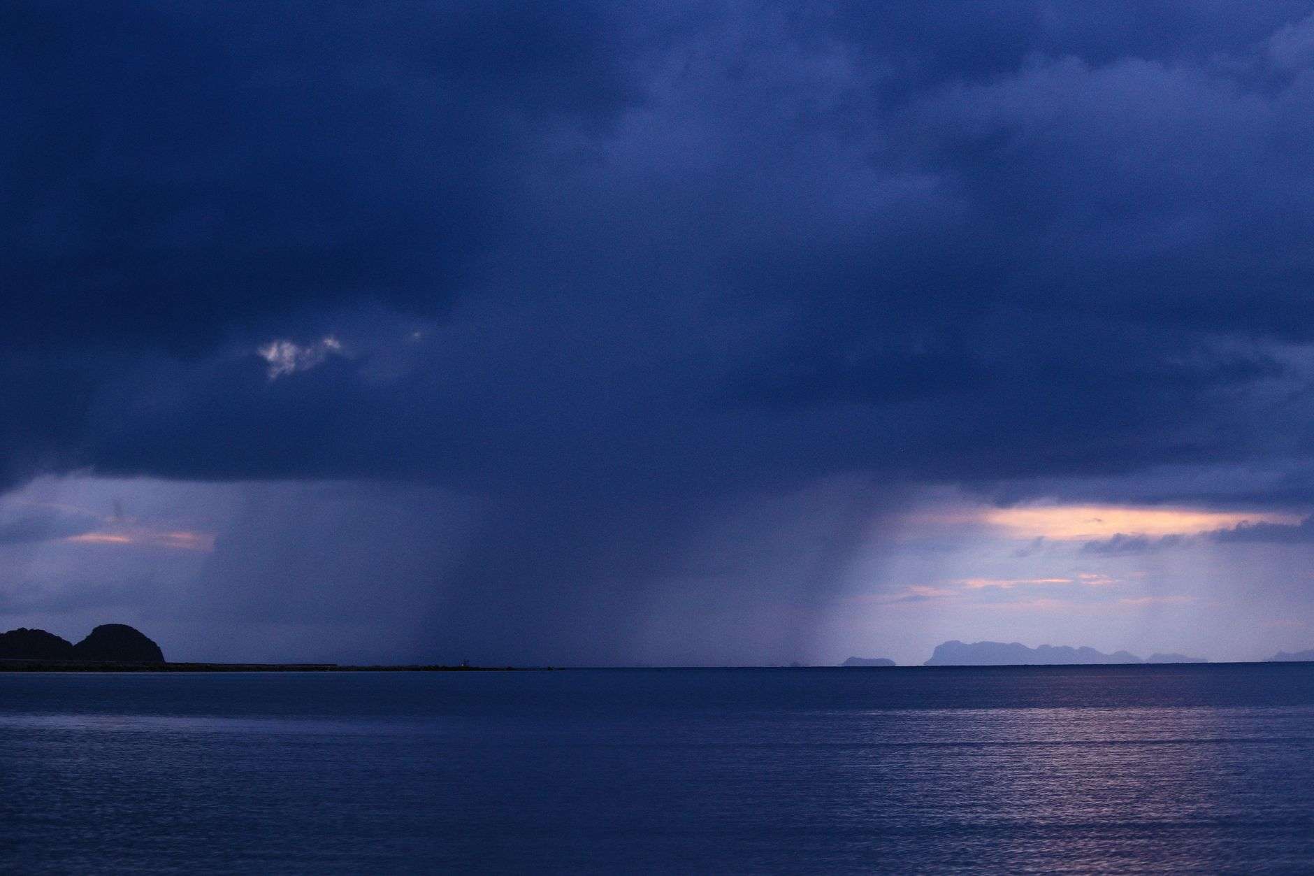 Dark storm clouds building over a coastline