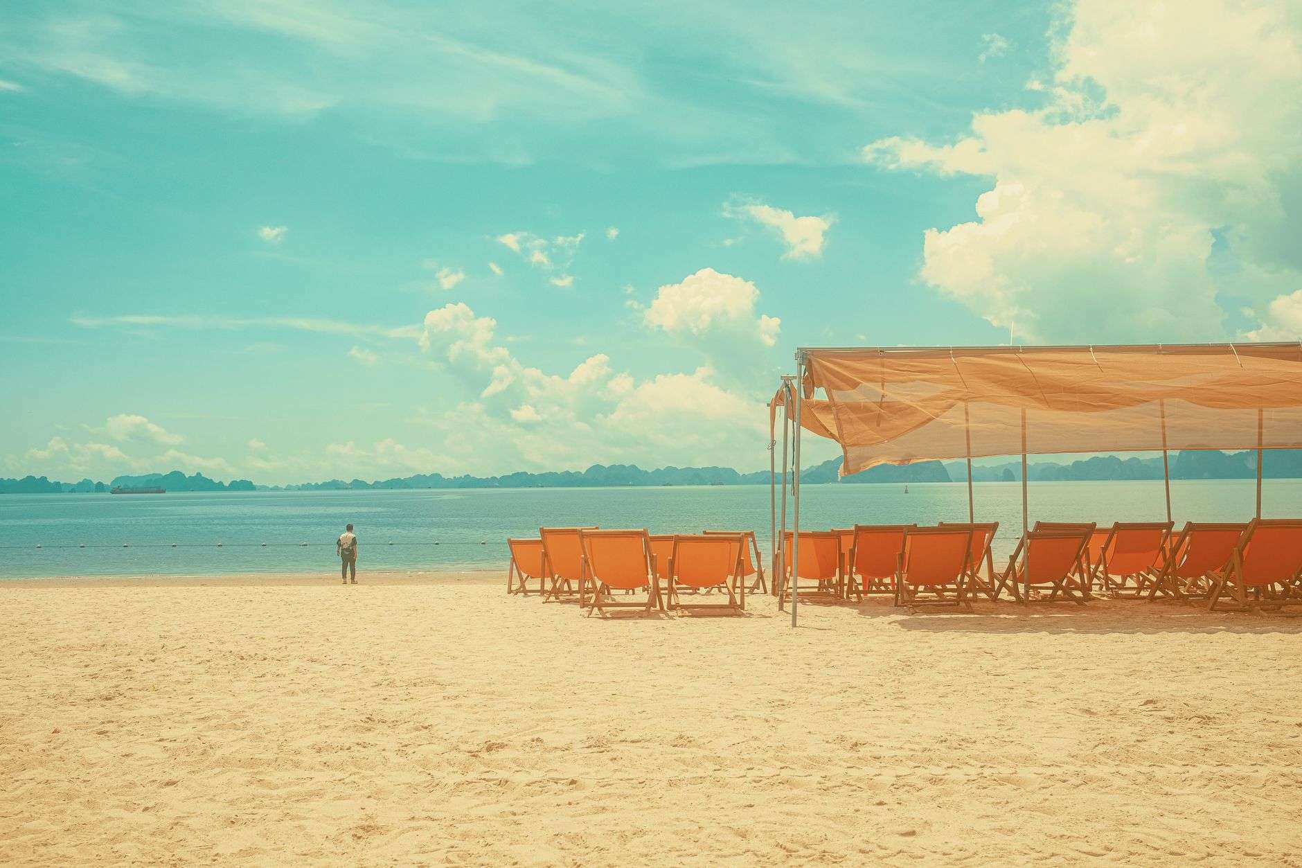 Bright sun over a coastal beach on a hot day