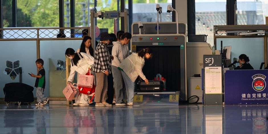 Luggage passing through an airport security screening machine