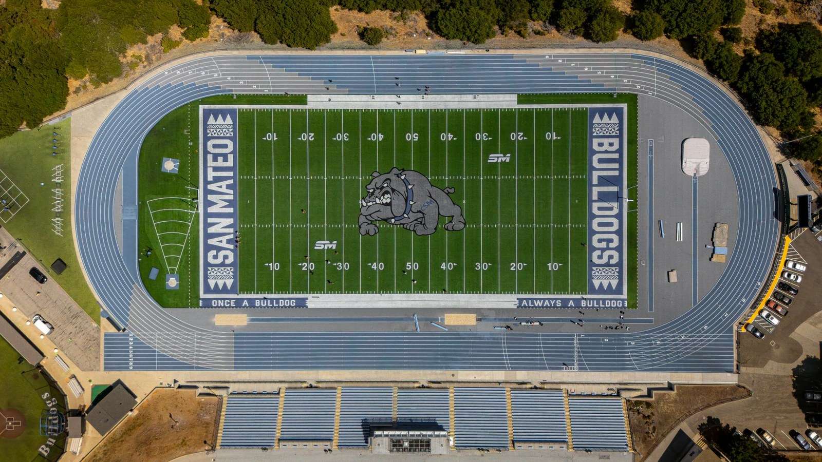 A high school football stadium with bleachers overlooking the field