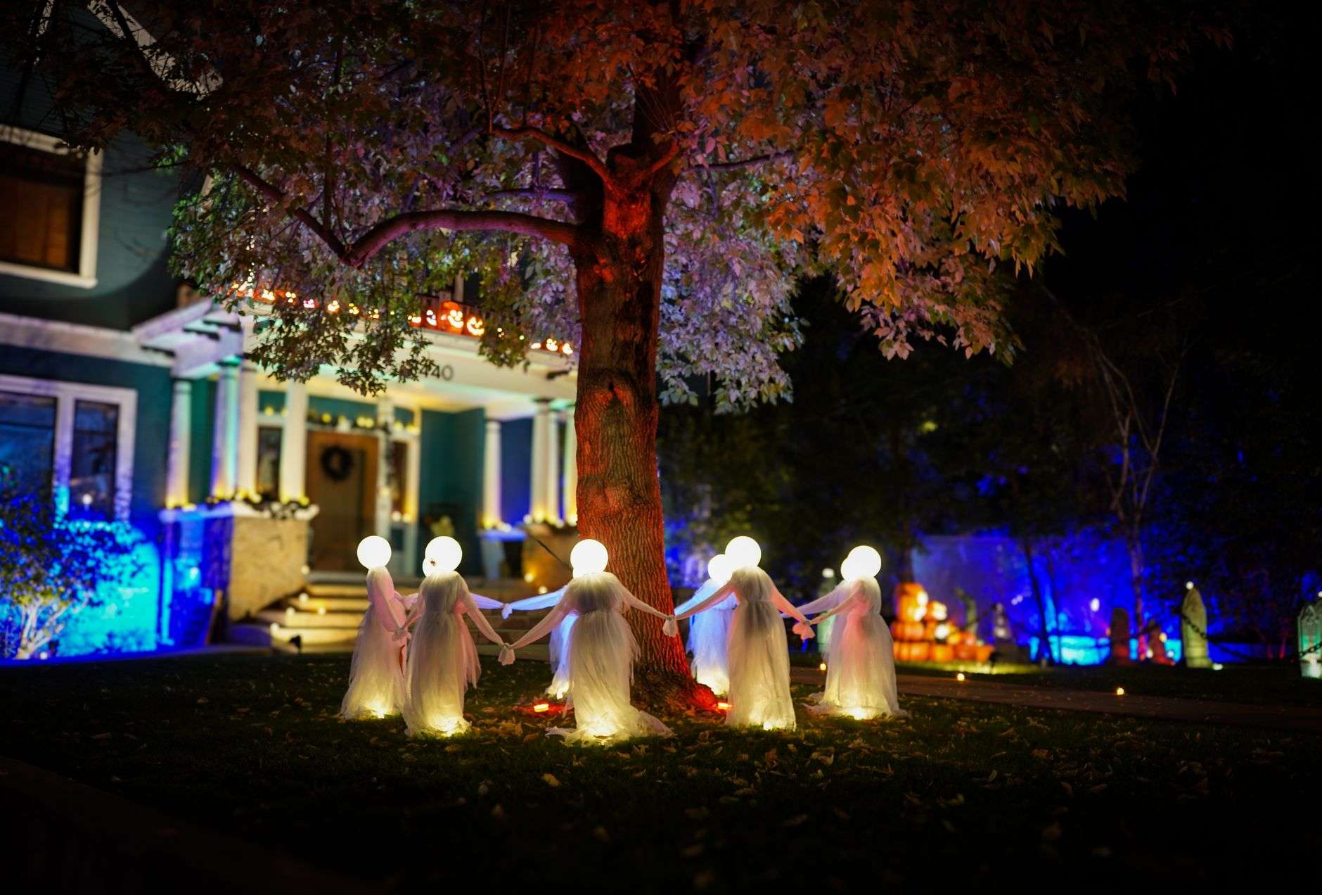 Spooky Halloween haunted house decorations lit up at night