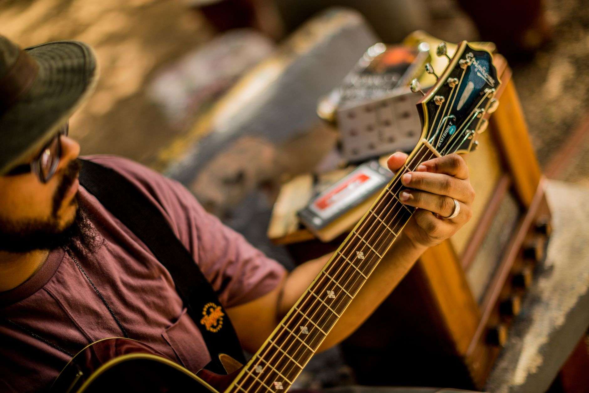 Acoustic guitars and stools arranged for an intimate songwriter performance