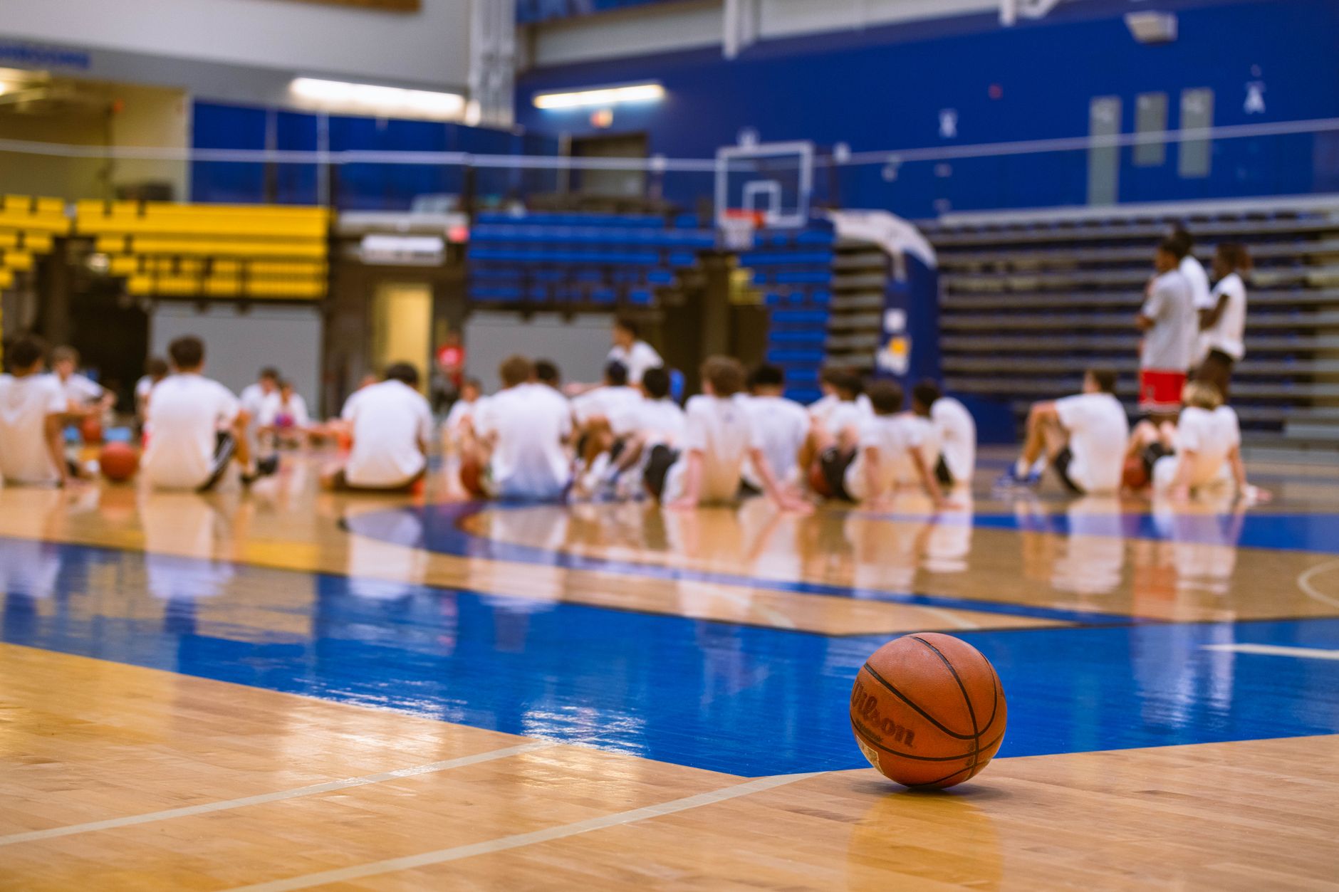 A high school gymnasium basketball court used for youth camps