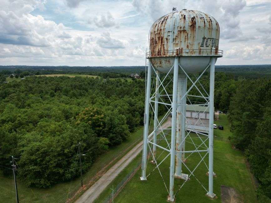 A water tower and utility infrastructure serving a rural community
