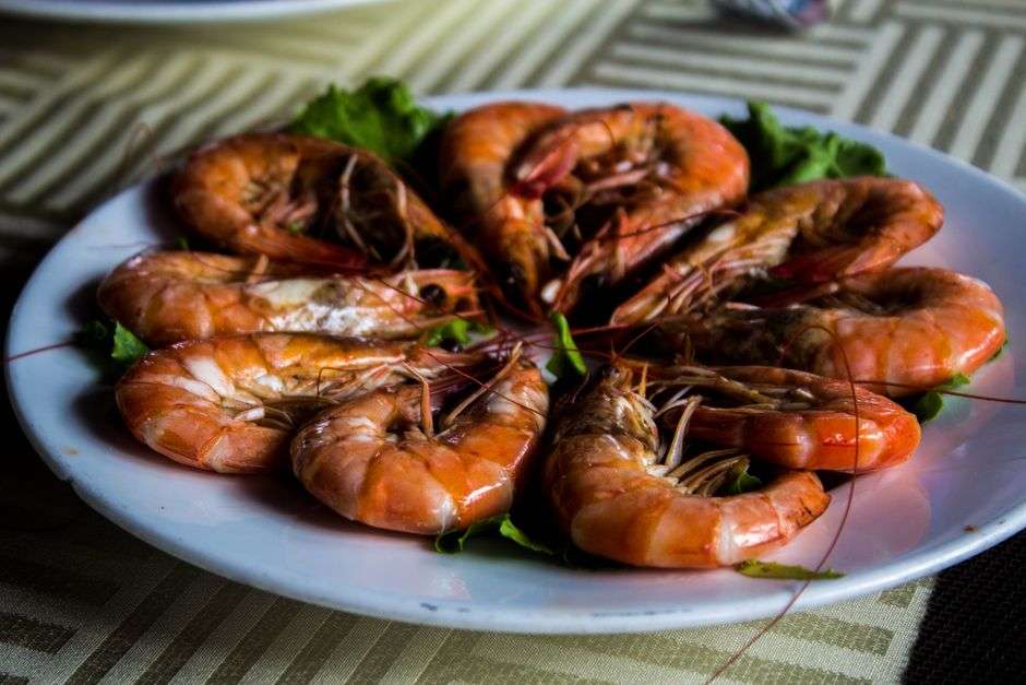 A plated dish of Southern shrimp and grits at a white-tablecloth restaurant