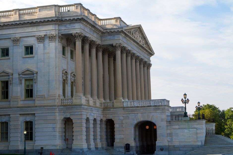 Columns of a capitol-style government building in daylight