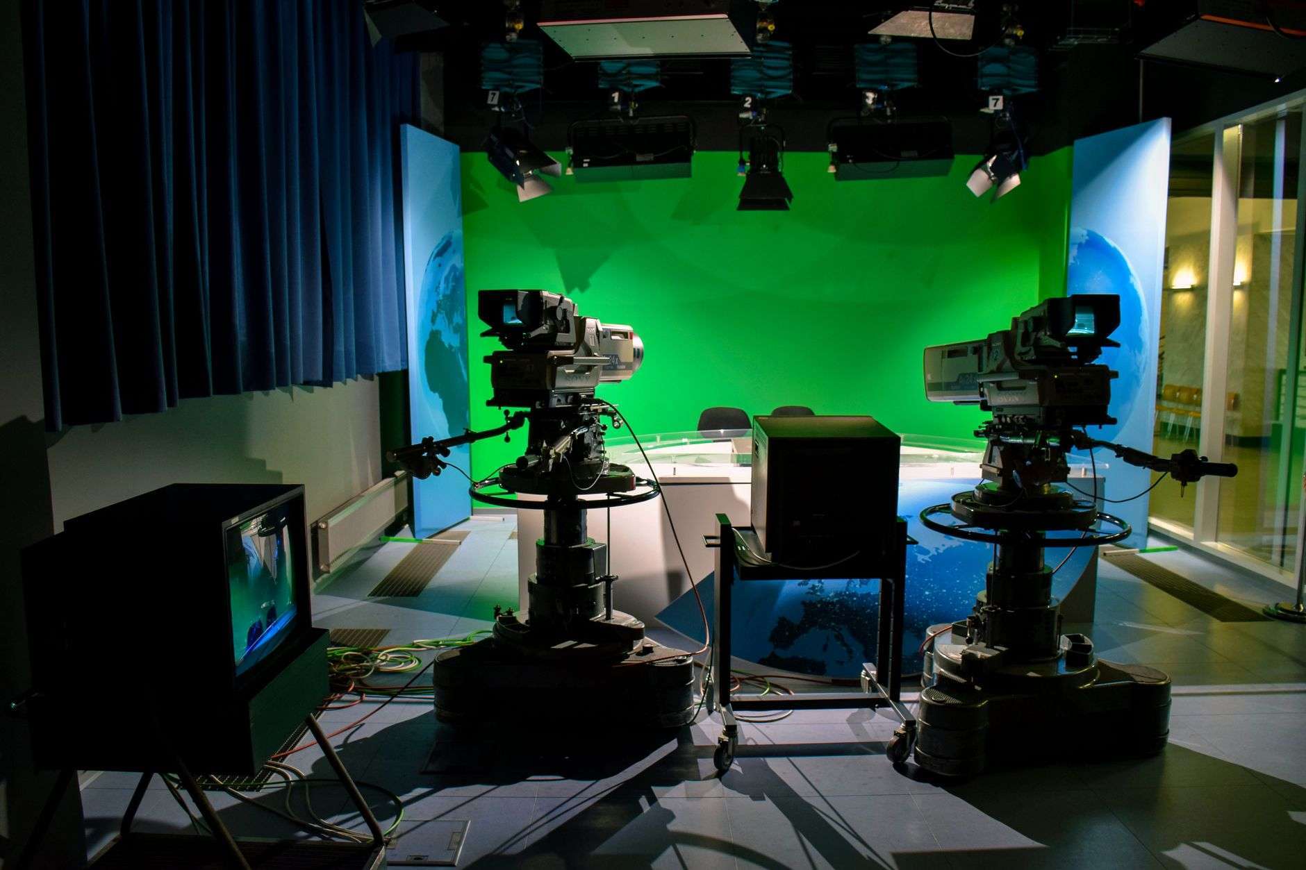 A broadcast camera in a television news studio