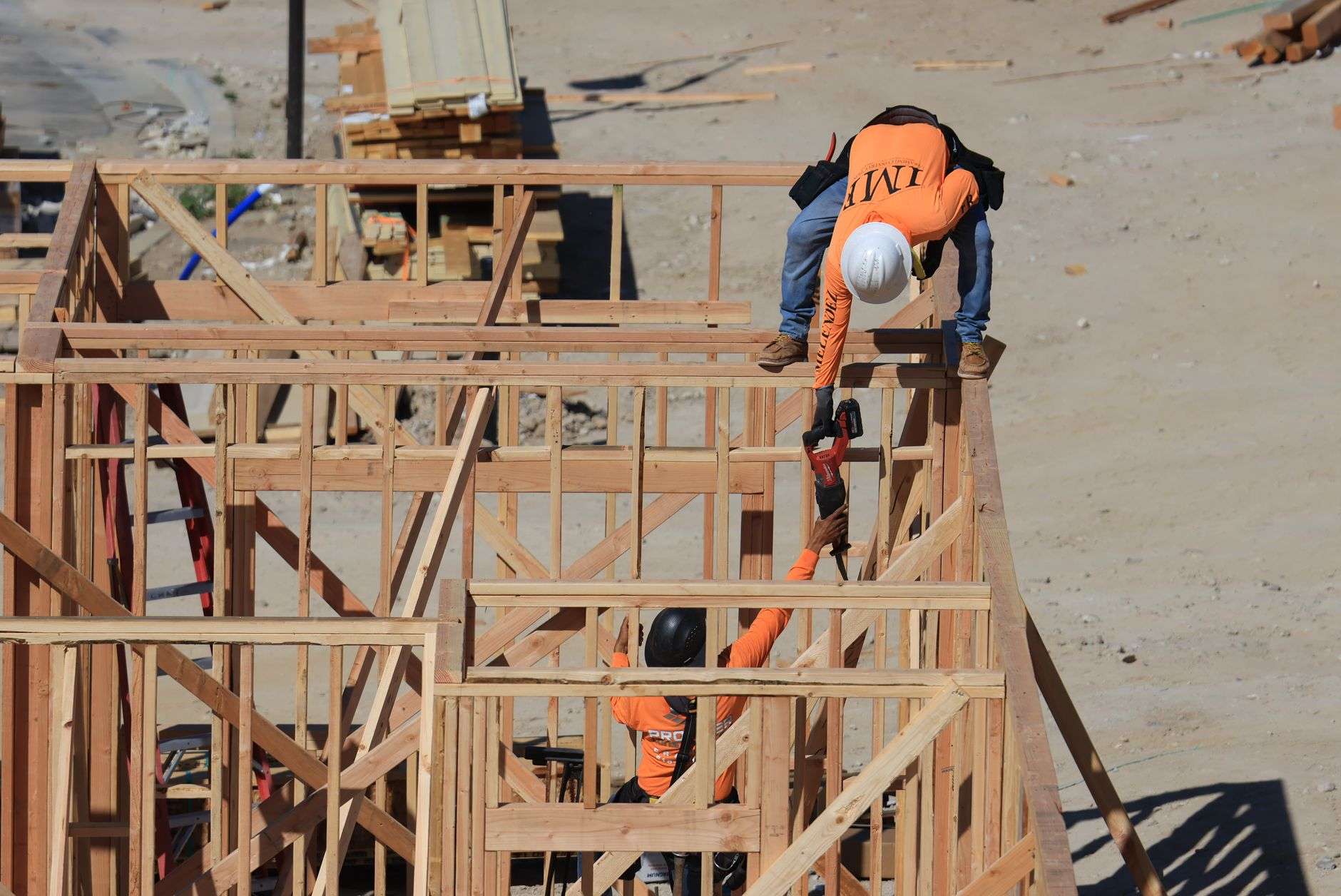 Construction workers framing a new house at a residential building site