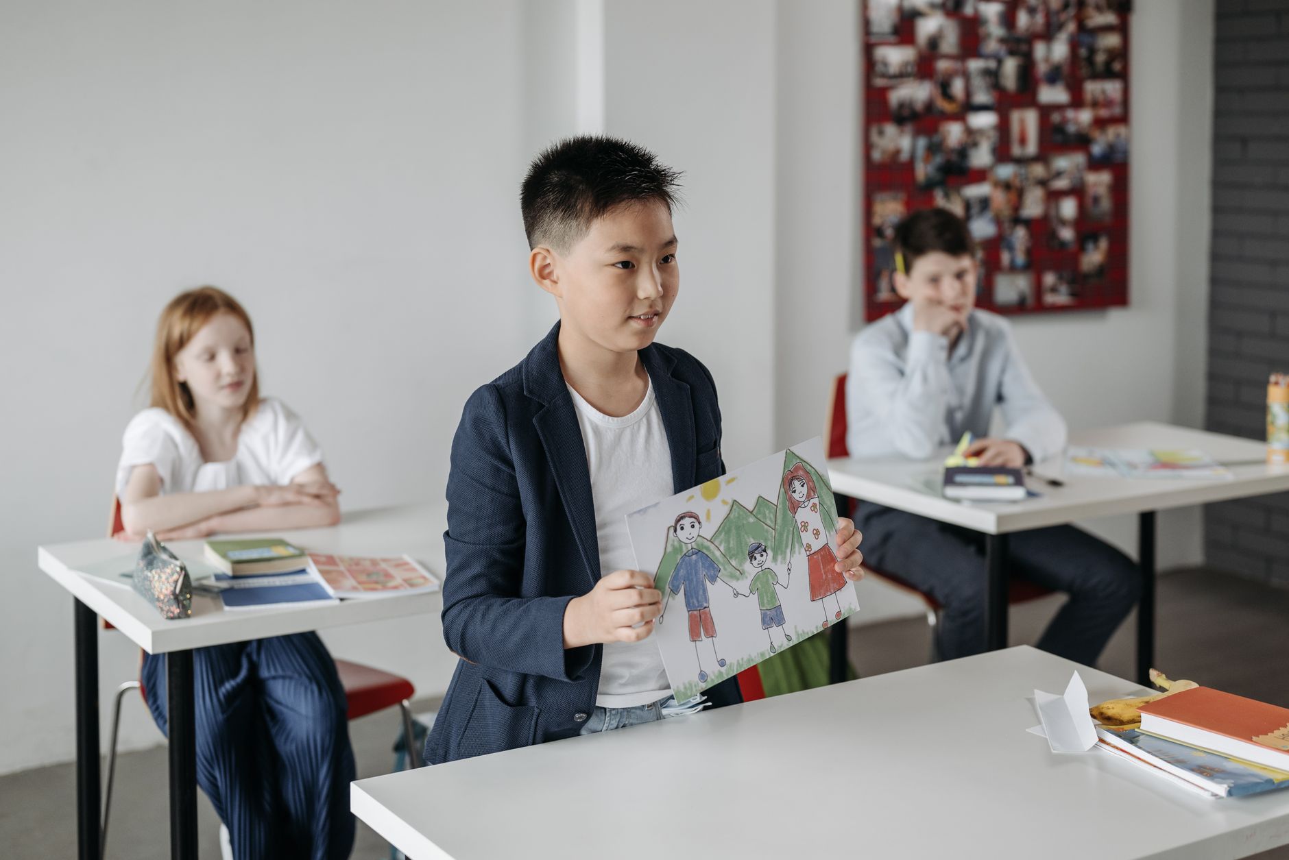 Elementary students work on an art project together in a classroom