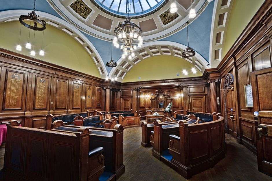 An American city council chamber with rows of empty seats