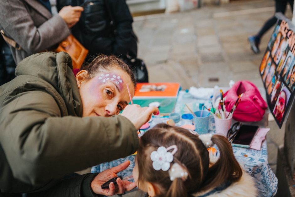 Families with children enjoying games and activities at an outdoor festival
