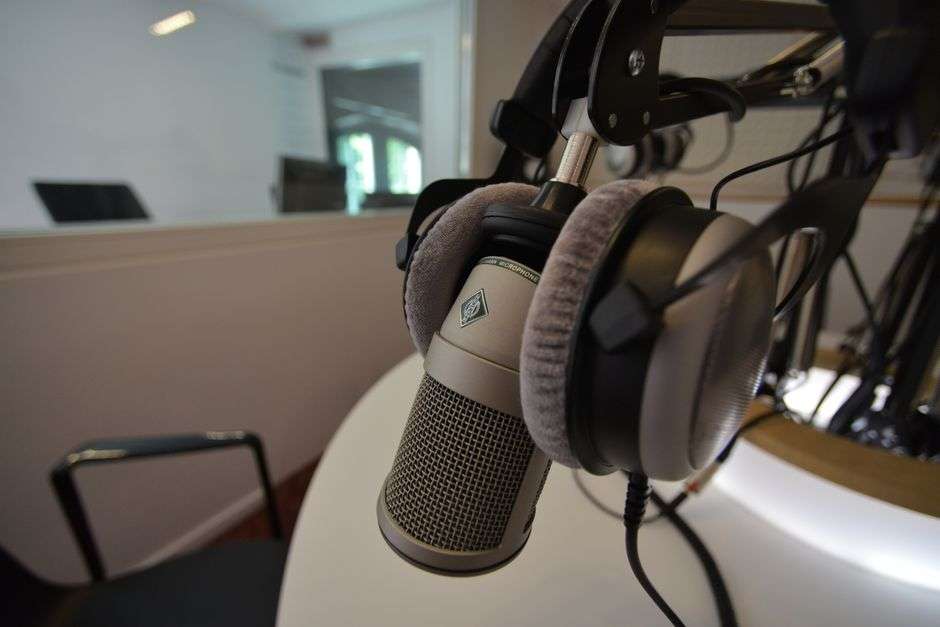 A microphone inside a modern radio station broadcast studio