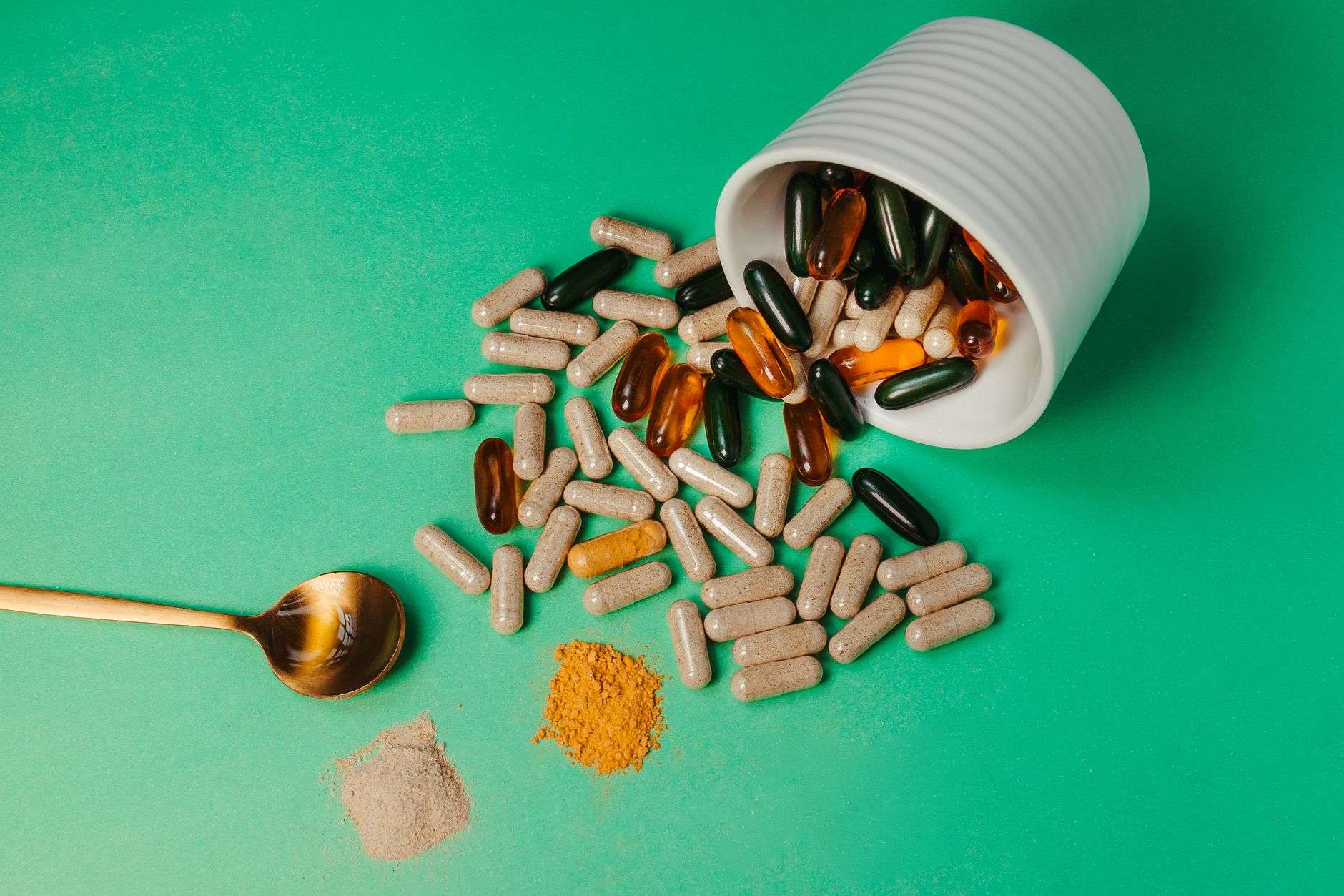 Green herbal powder and capsules on a table