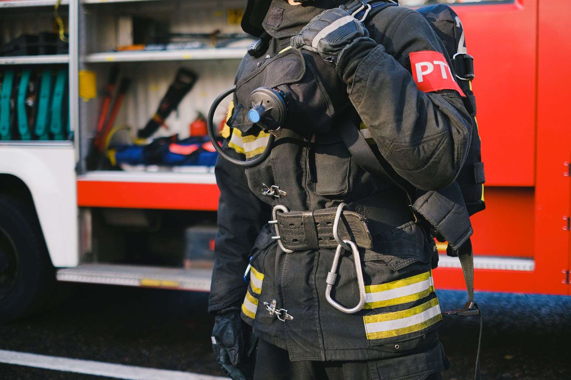 Emergency responder in uniform beside equipment
