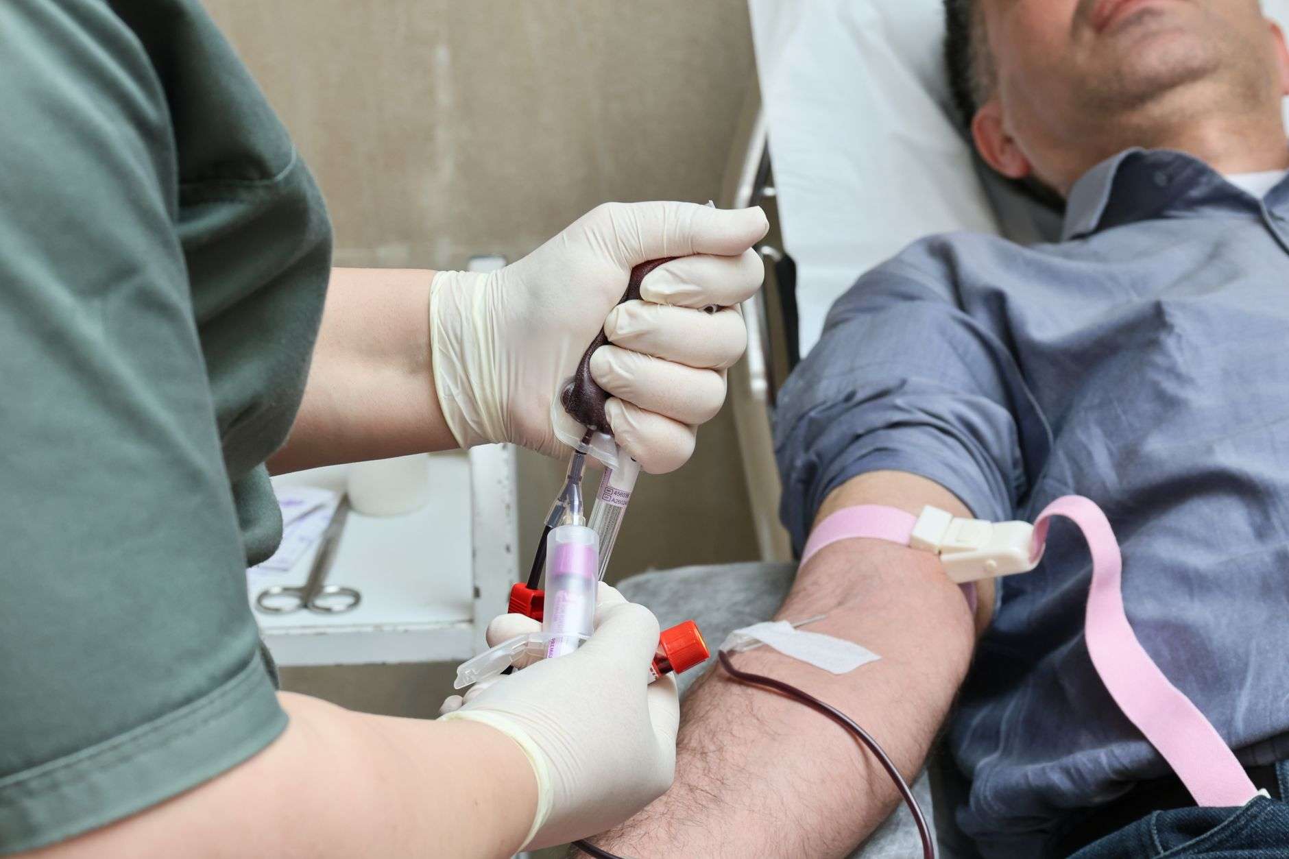 A volunteer donor giving blood at a community blood drive