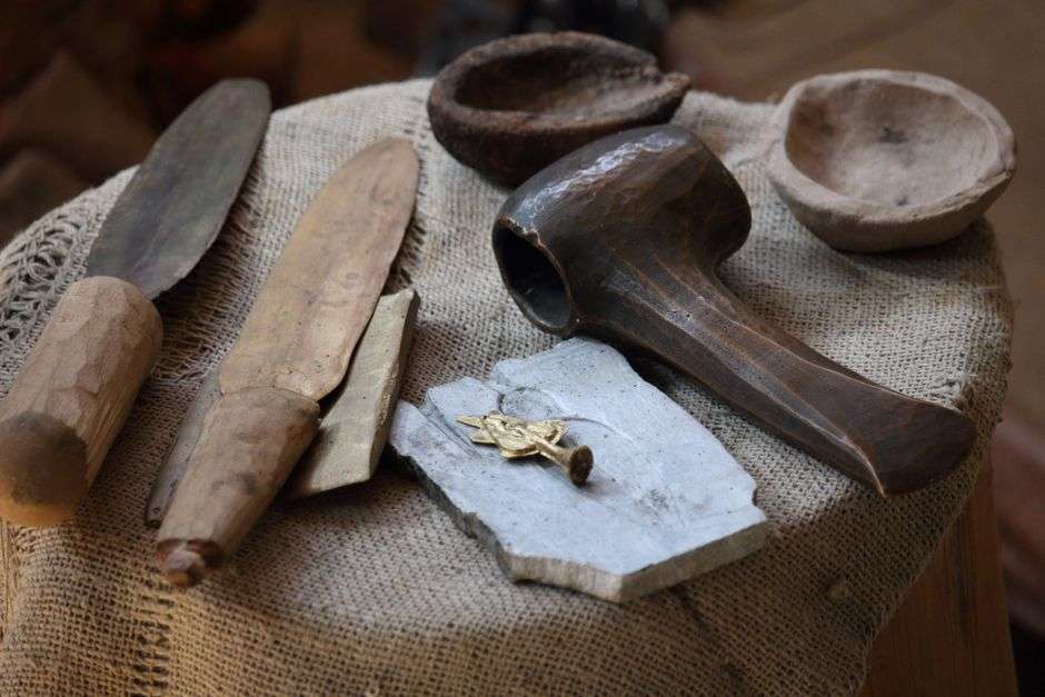 Archaeologist screening soil for artifacts at an excavation site