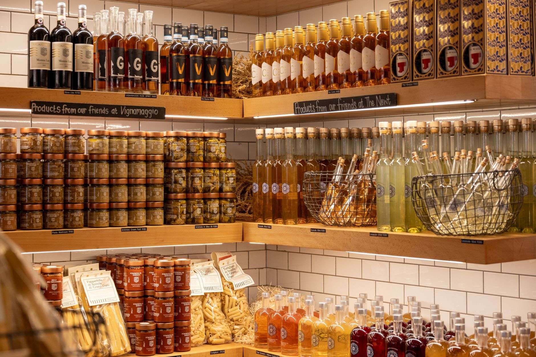 Rows of olive oil and balsamic vinegar bottles on a shop shelf