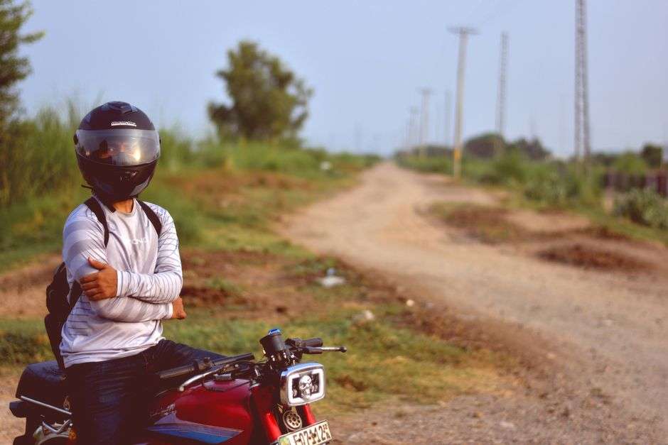 A motorcycle traveling down a rural two-lane road