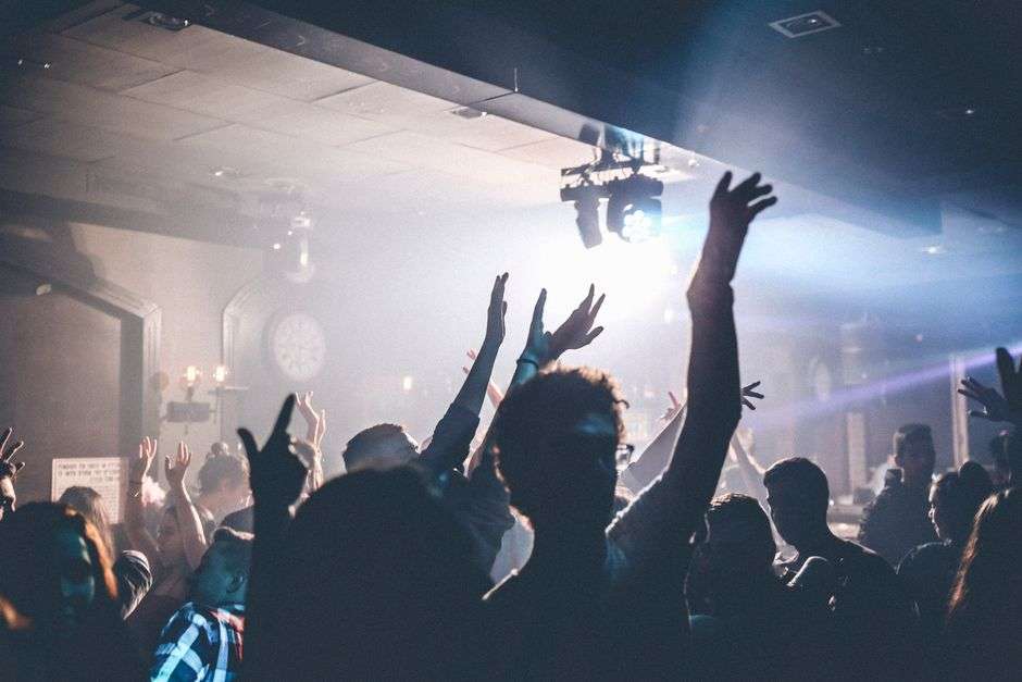 A country music bar dance floor lit by stage lights at night