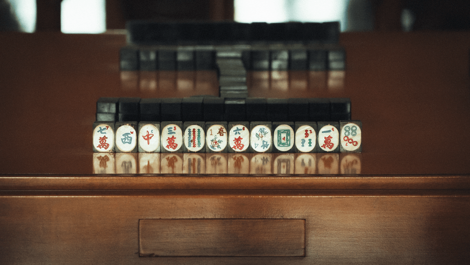 Colorful mahjong tiles arranged on a playing mat