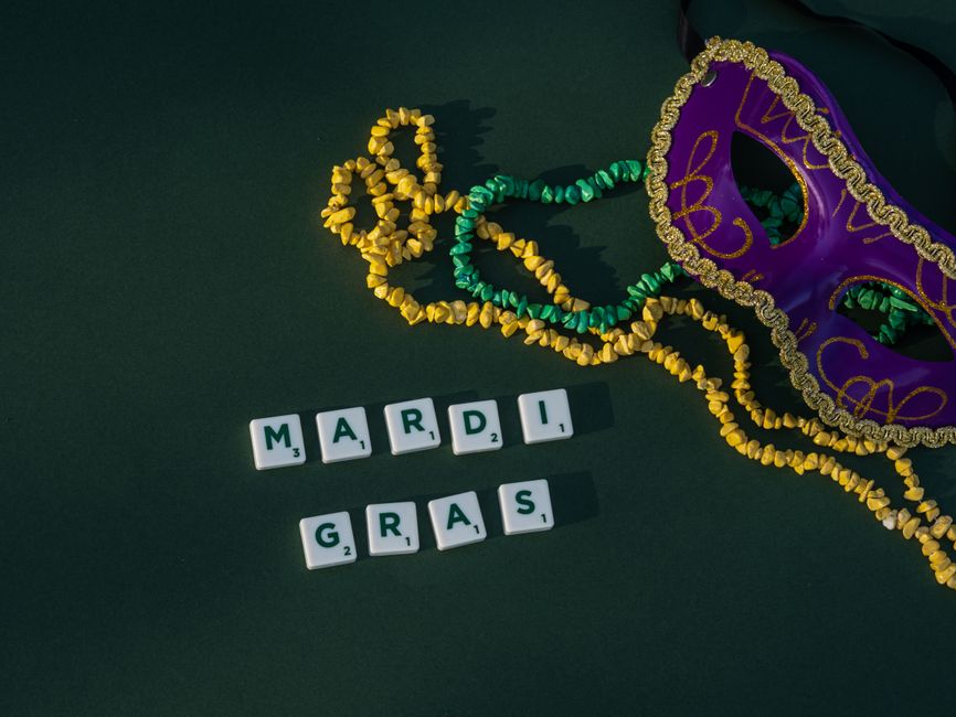 Piles of purple, green and gold Mardi Gras beads