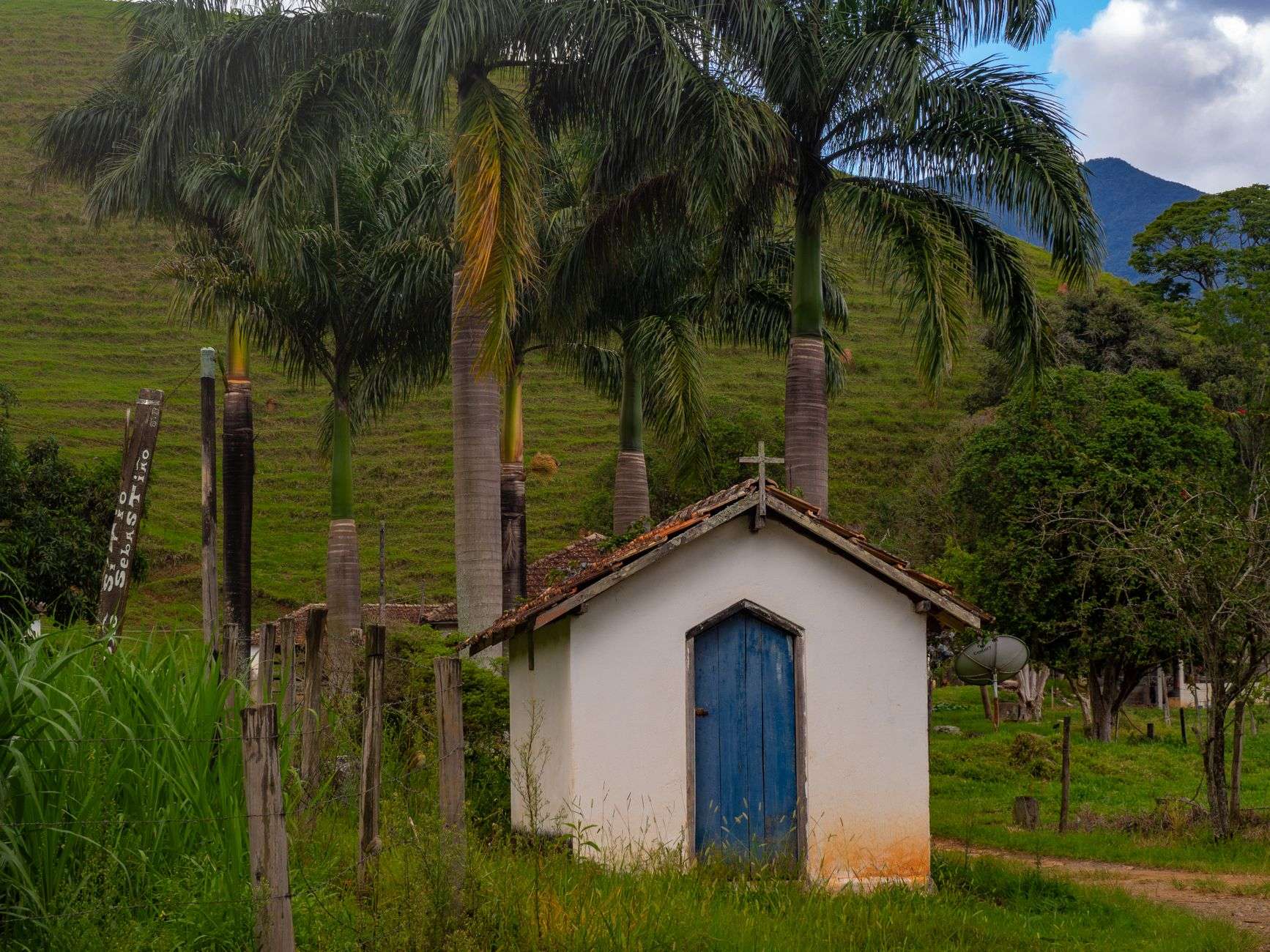A small white country church standing in an open rural landscape