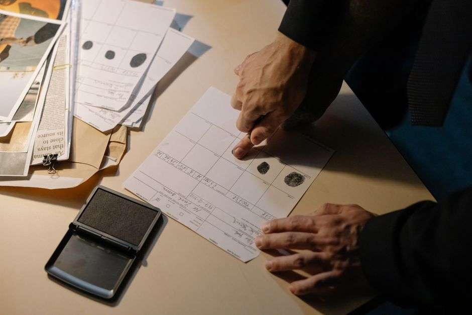 A police detective working at a laptop computer during an investigation