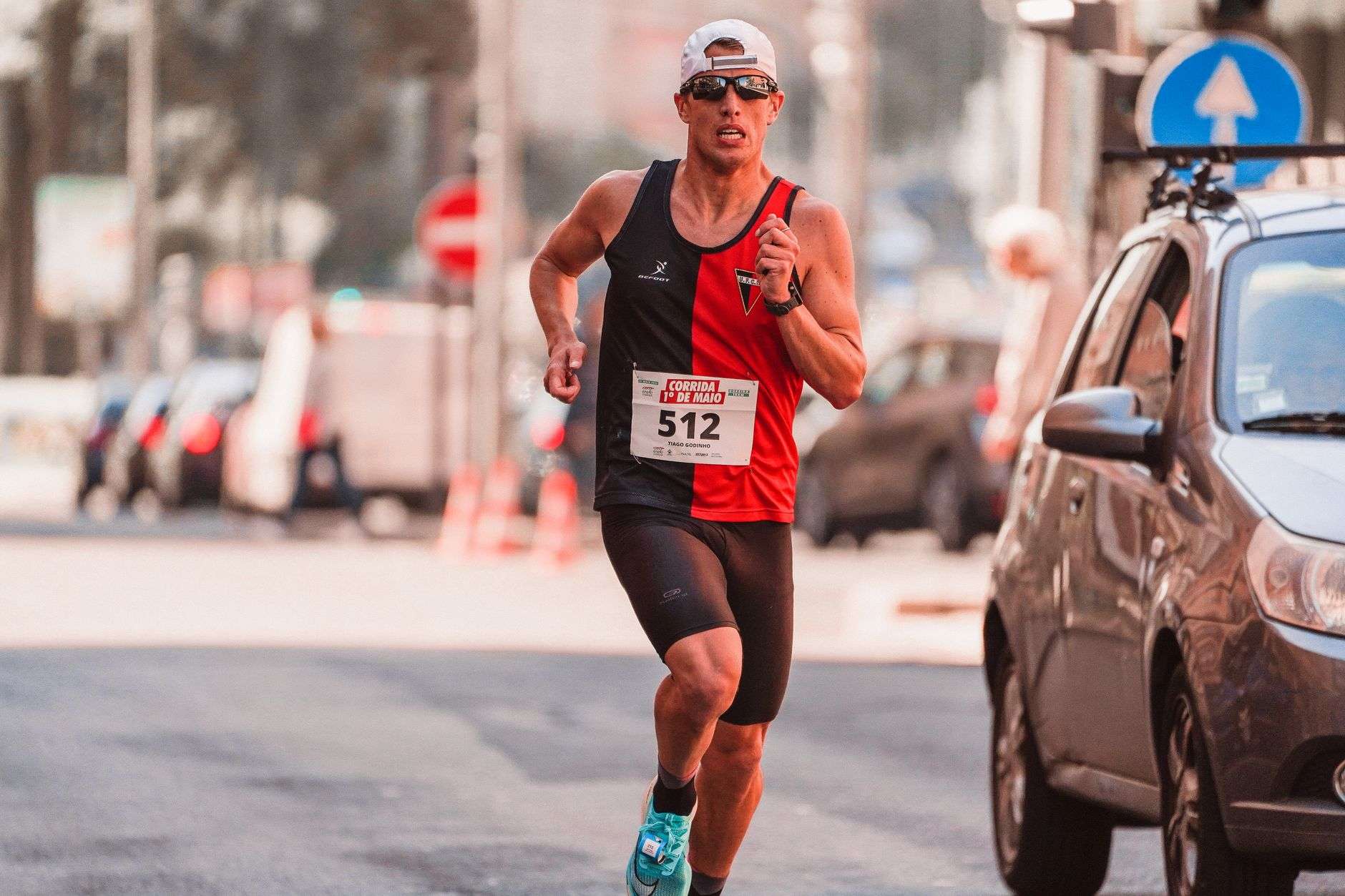 Runners making their way down a street during a community 5K race