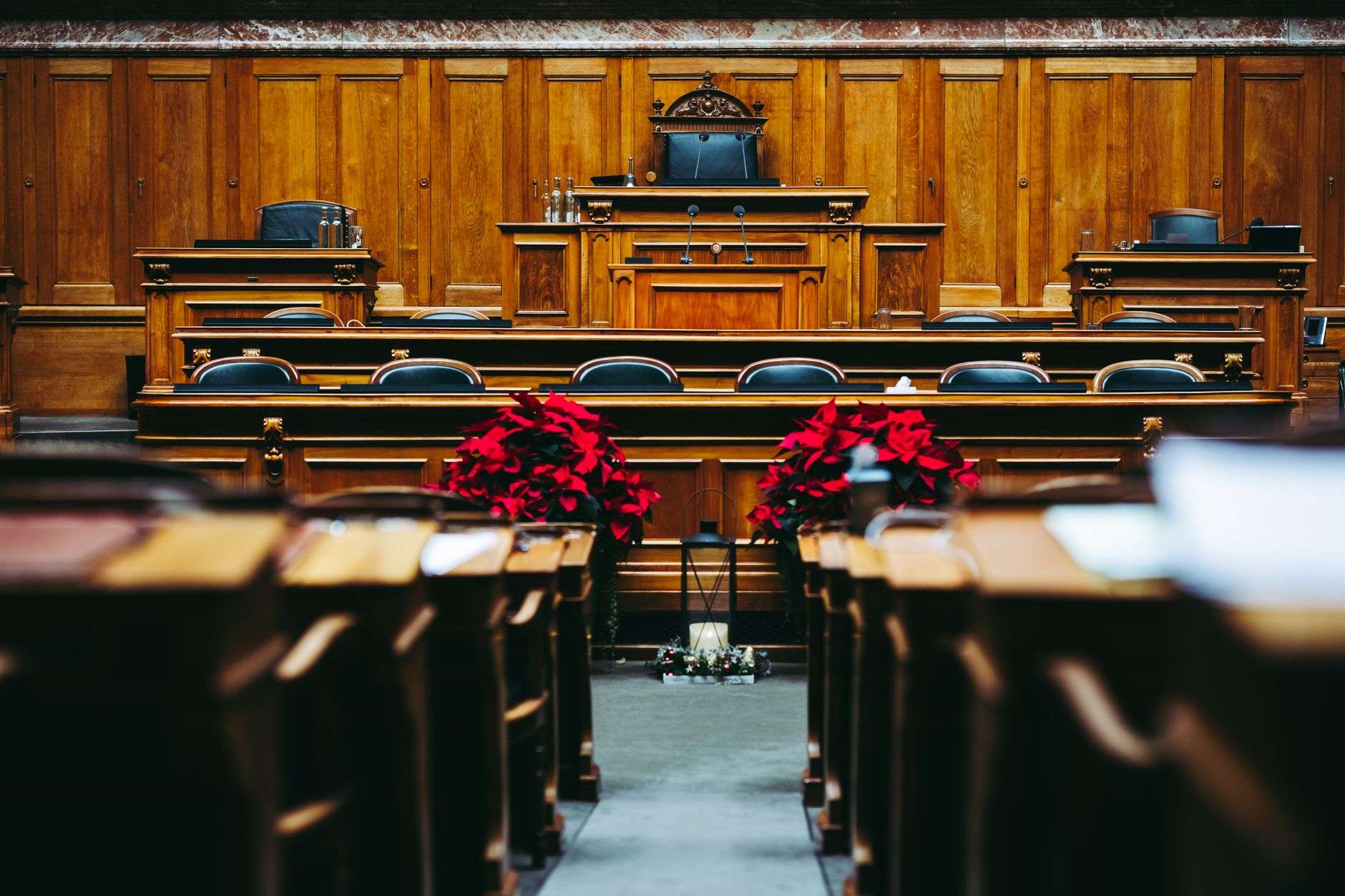 The interior of a courtroom with benches and a judge's bench