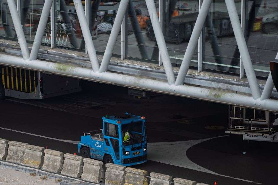 Construction site of a modern airport terminal with cranes and structural steel