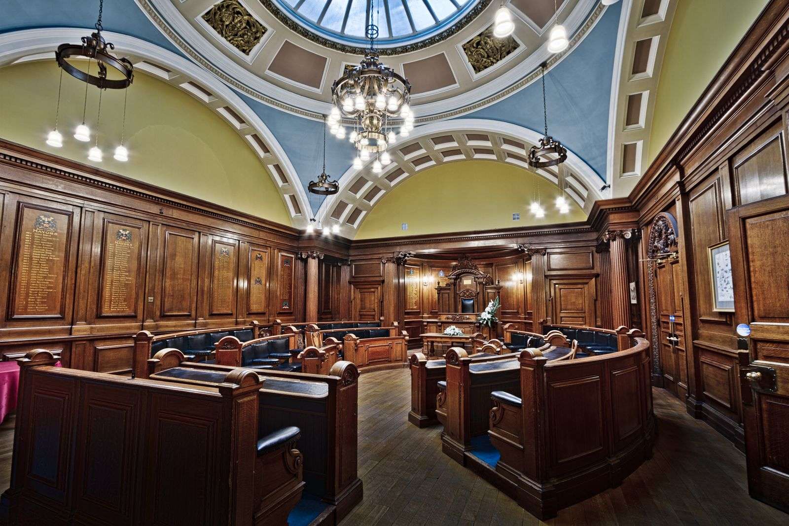 Empty council chamber seats and dais in a government meeting room