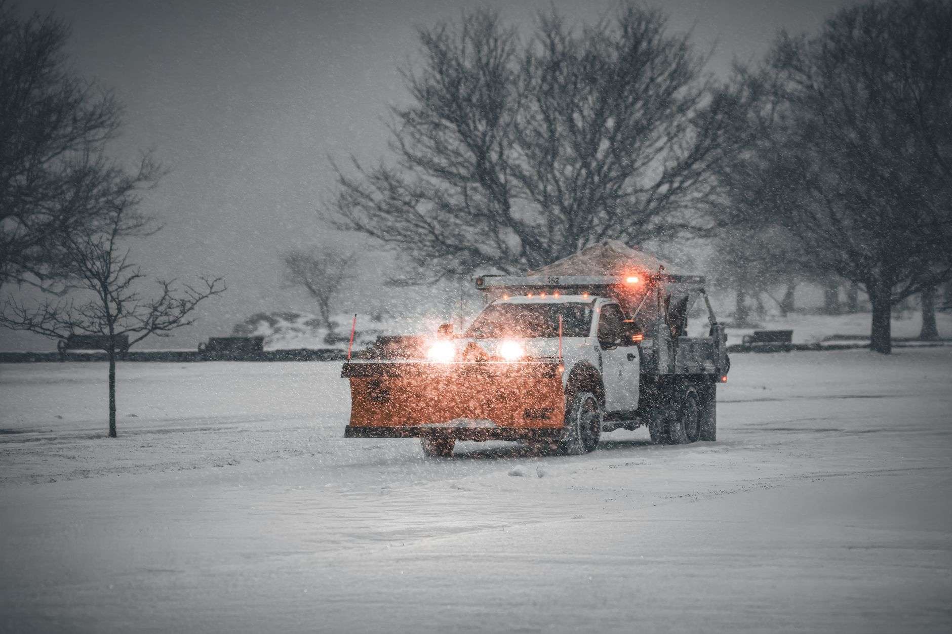 Snow plow blade mounted on a large work truck