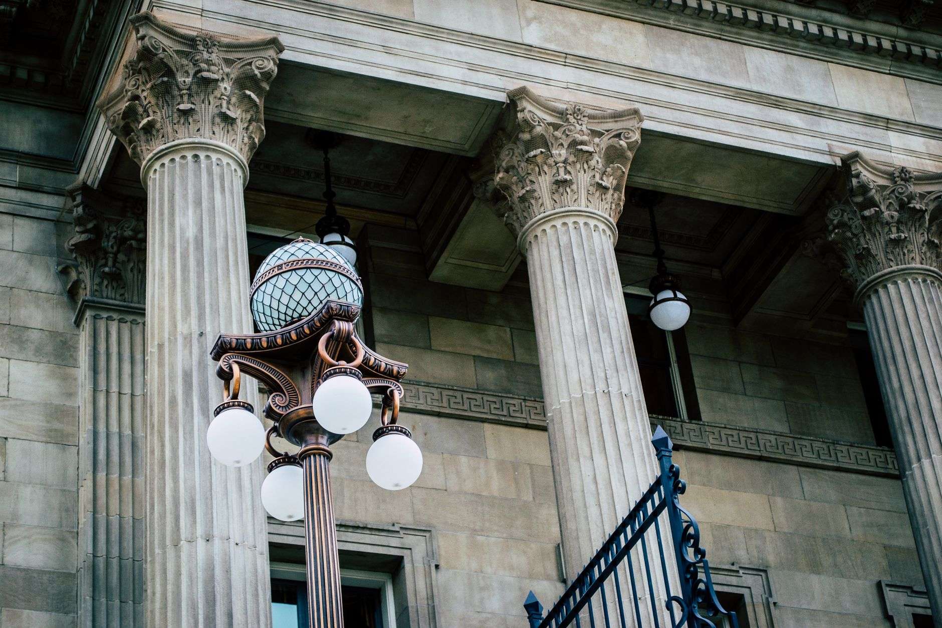 A courthouse exterior with stone columns, illustrating grand jury indictments returned in a county court