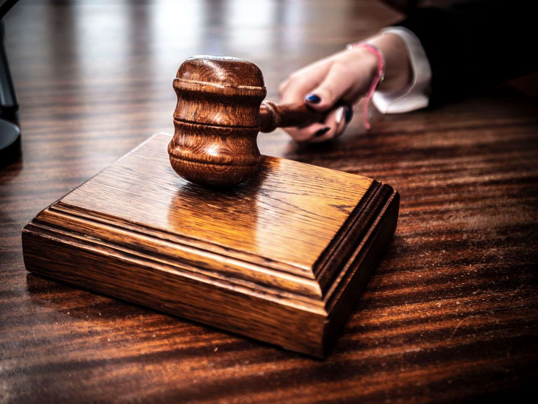 An empty courtroom with a jury box and wooden benches