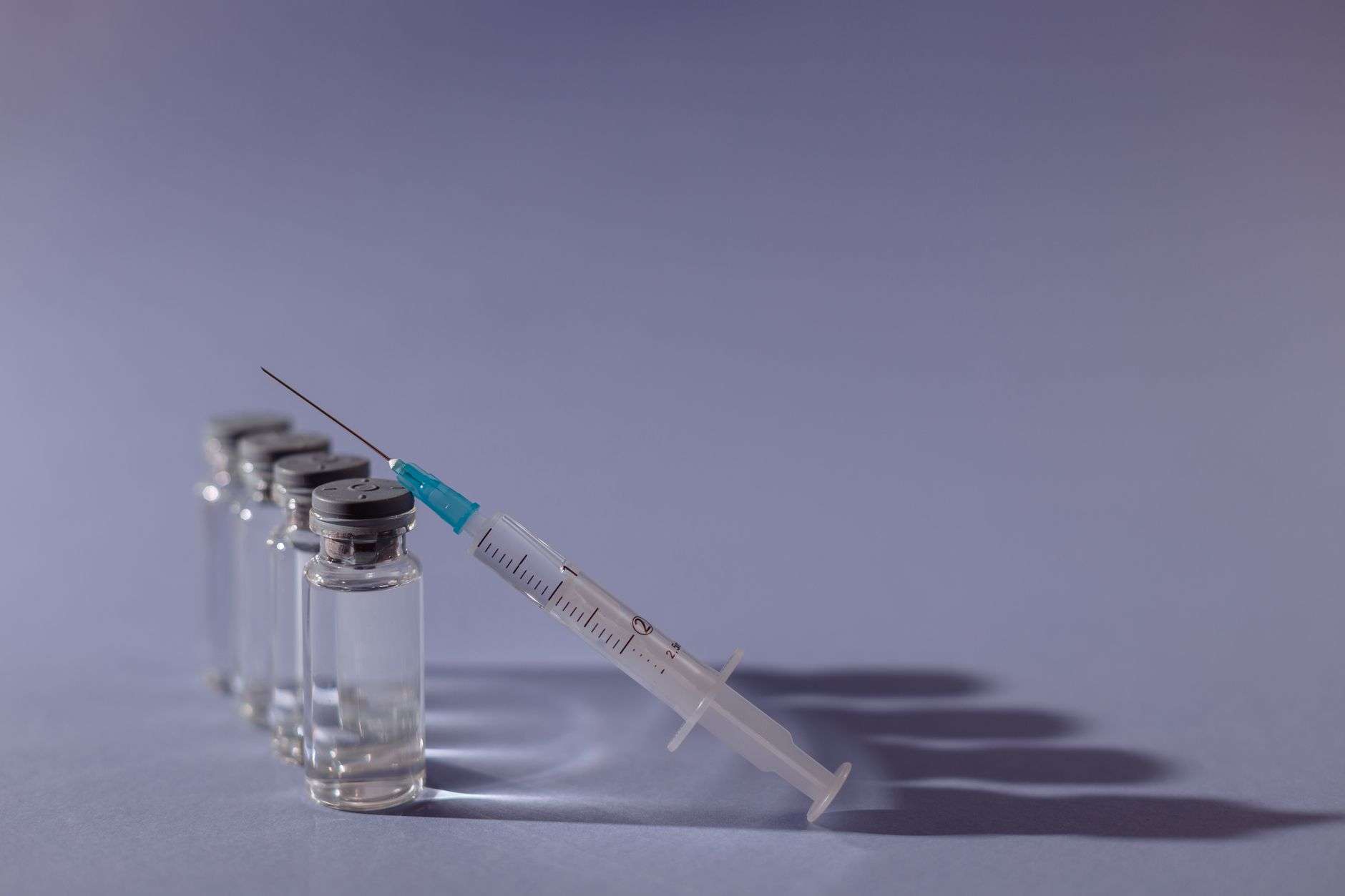 Vaccine vial and syringe on a medical tray