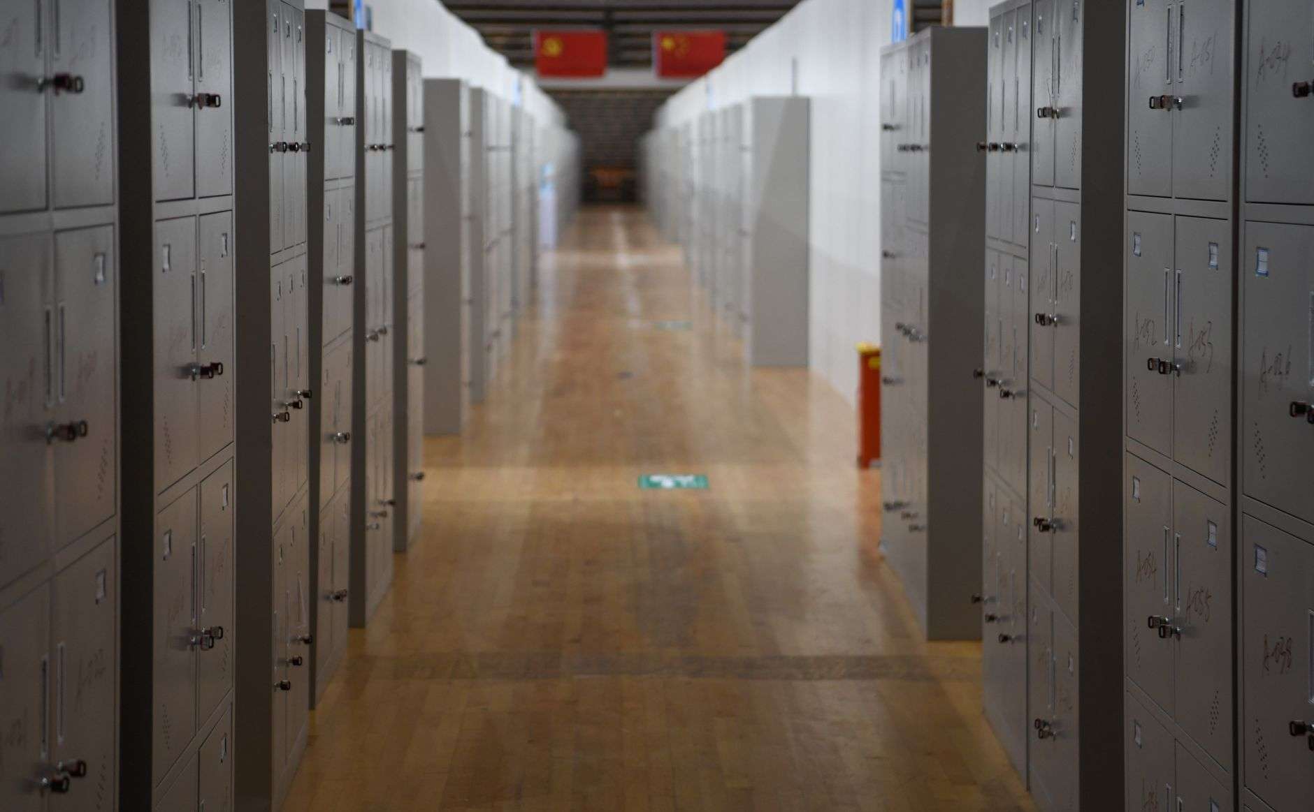 An empty high school hallway lined with lockers during class hours