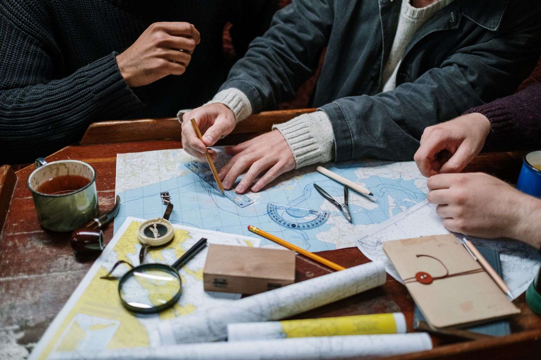 People reviewing a neighborhood map and planning documents at a table