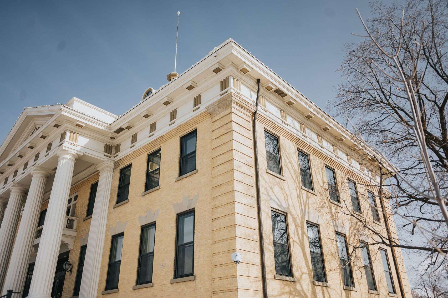 Exterior of a county courthouse building with stone columns and steps