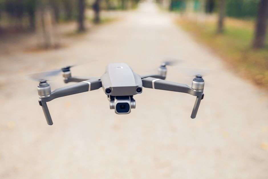 A drone hovering above a public park
