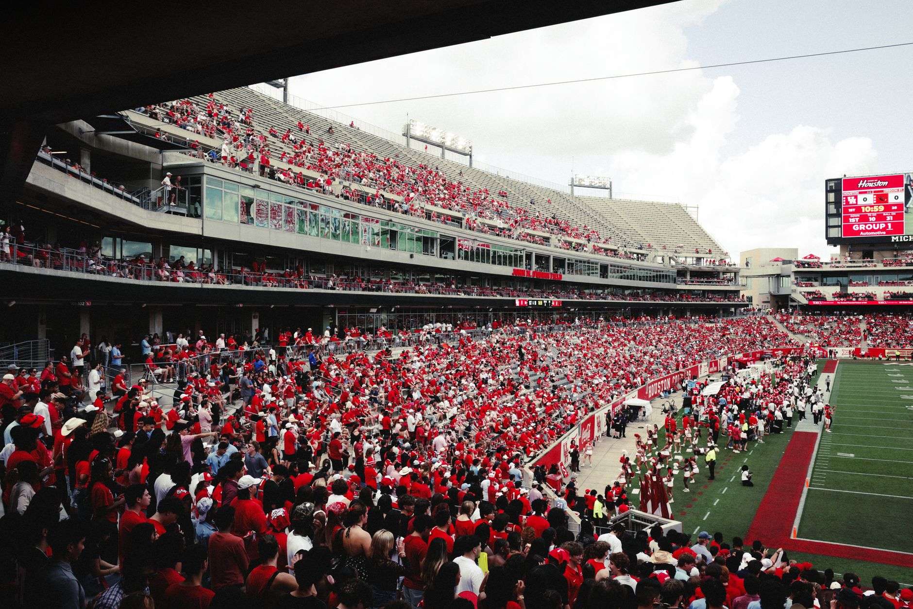 A college football stadium filled with spectators during an evening game