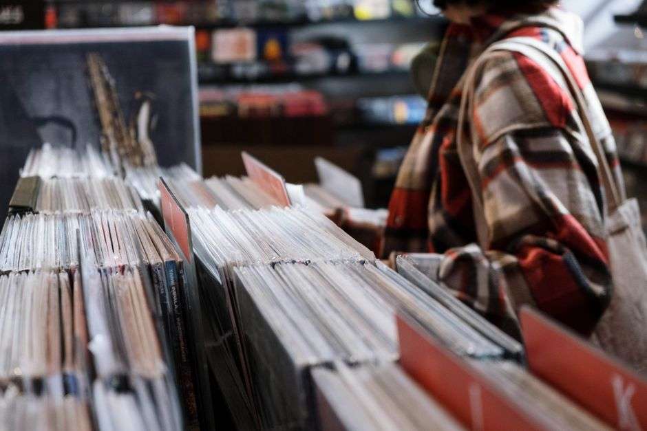 Shelves packed with vinyl records in a record shop
