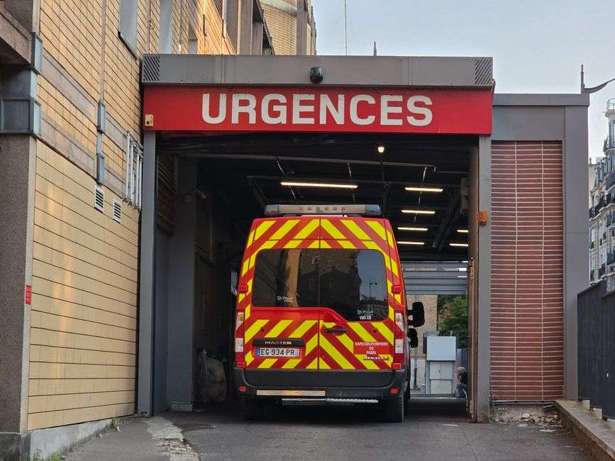 Ambulance parked outside a hospital emergency entrance at night