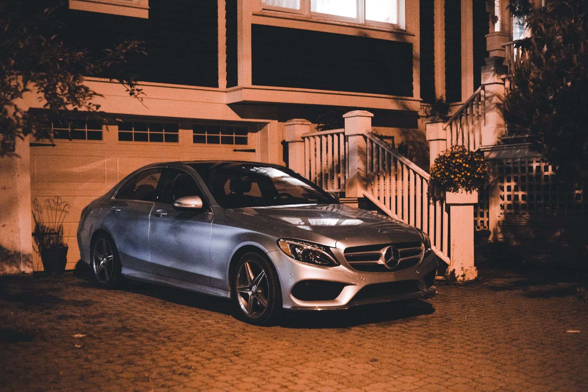 Vehicle parked in a residential driveway at night