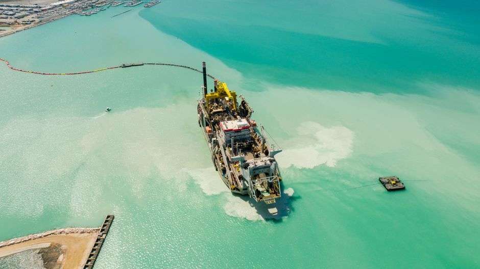 A dredging vessel operating in a coastal bay
