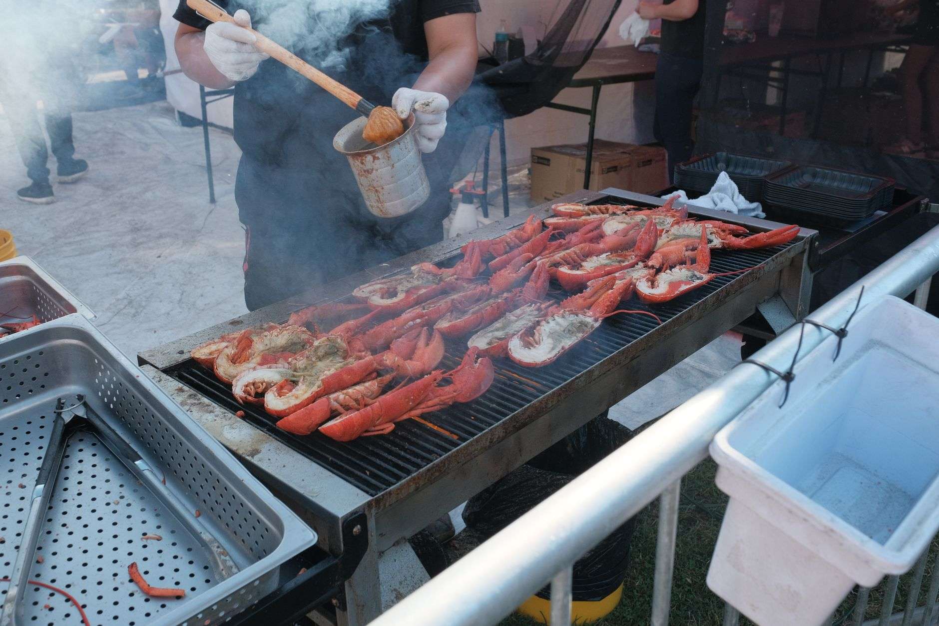 Visitors moving among food booths at an outdoor seafood festival