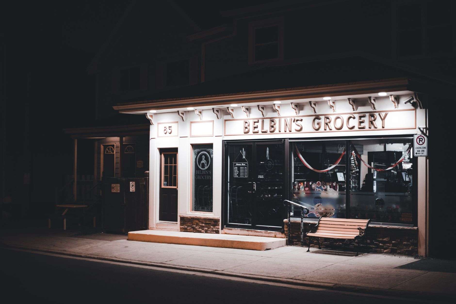 A small neighborhood grocery and deli storefront, illustrating an independent market at the center of a rezoning debate