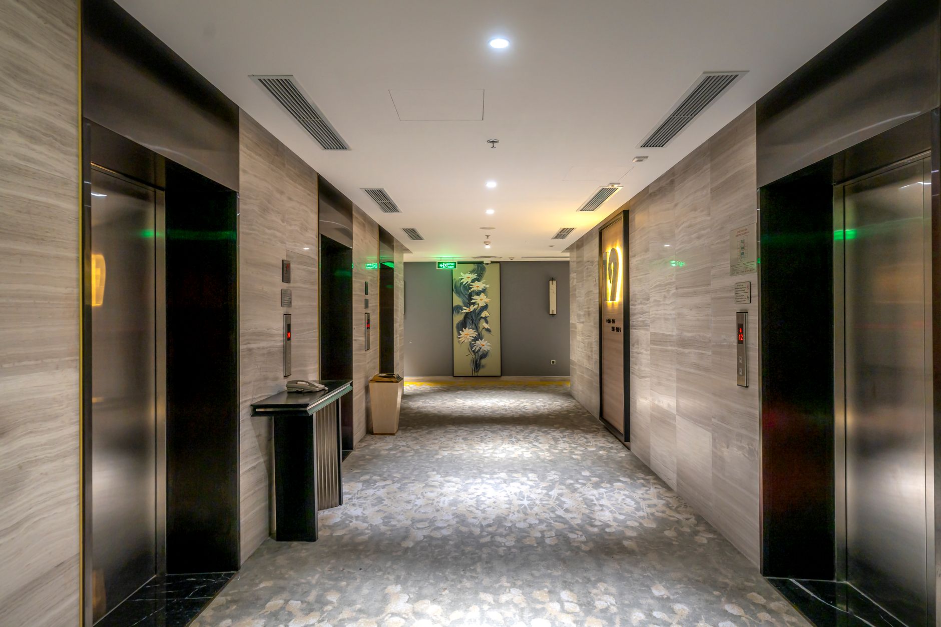 Bright, modern hotel lobby with a front desk and seating area
