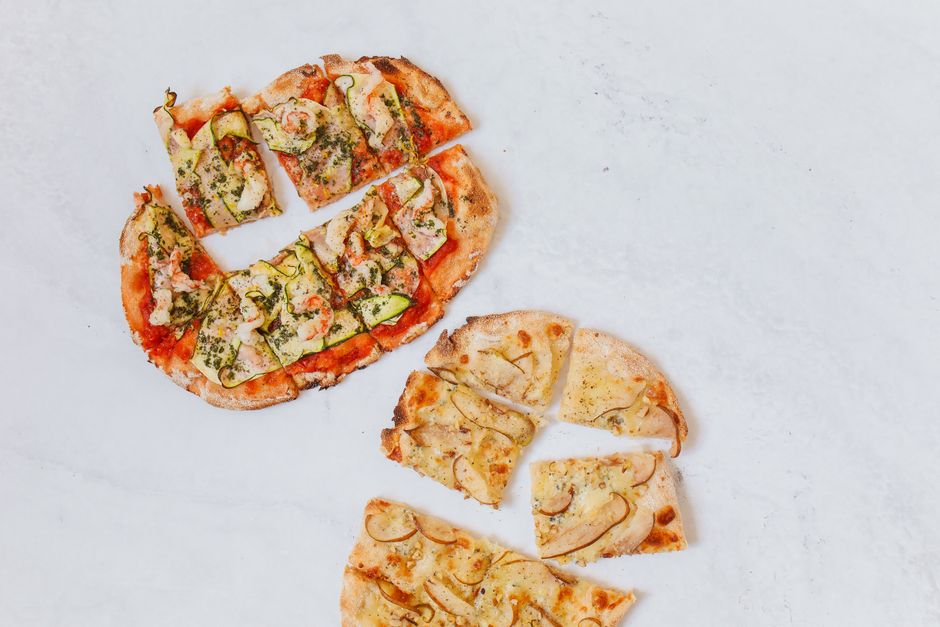 Square-cut pizza slices served on a table at a small pizzeria