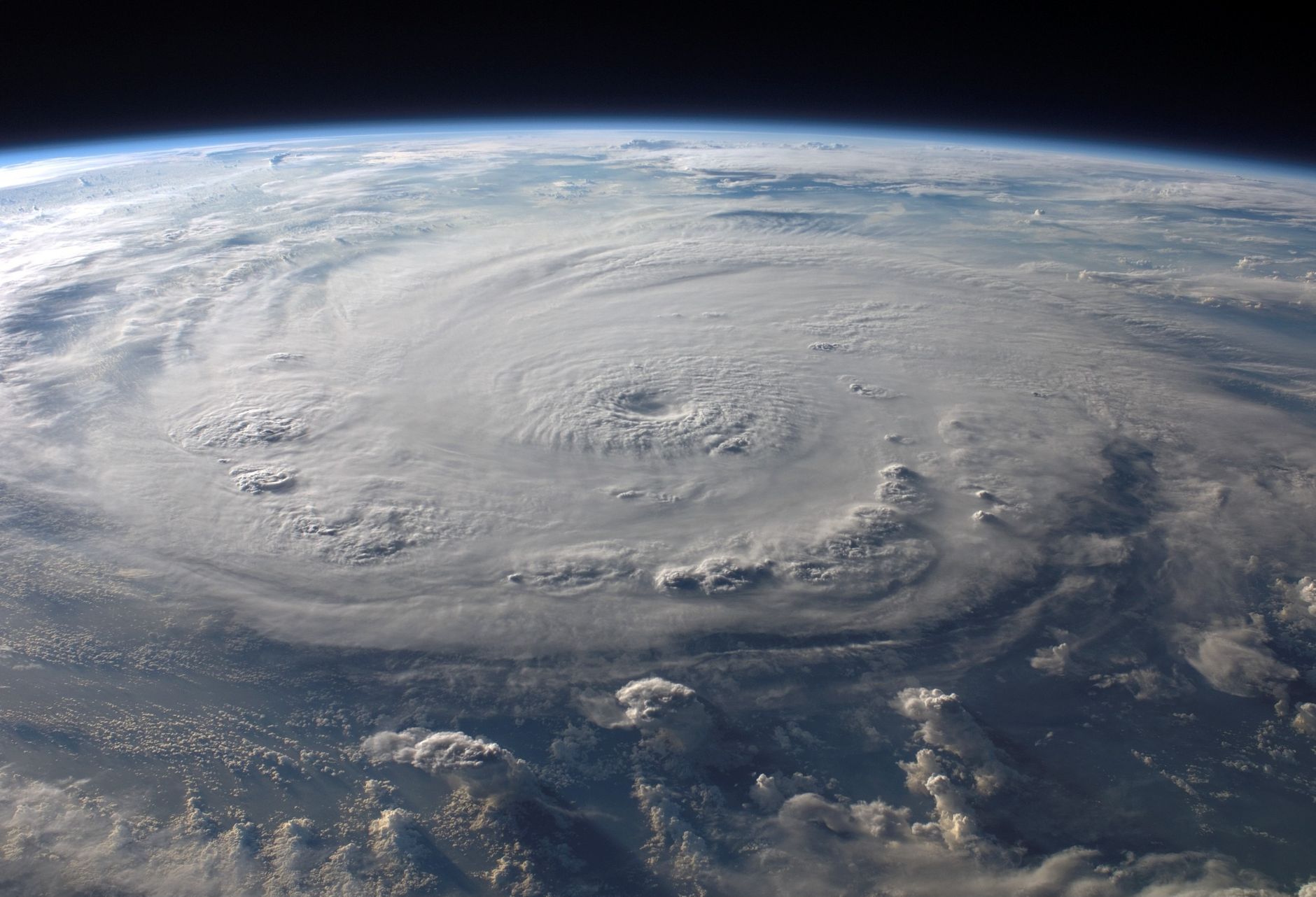 Swirling storm clouds gathering over open ocean water